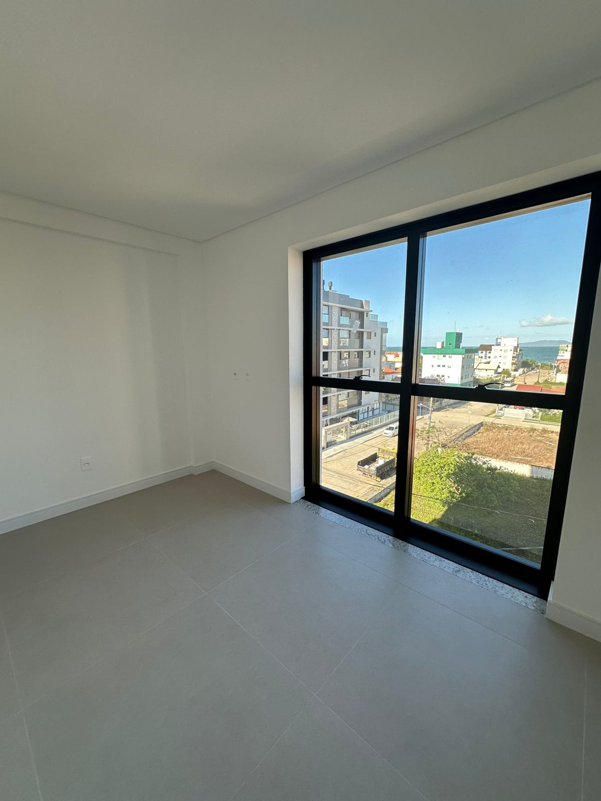 Spacious bedroom with window and sea view