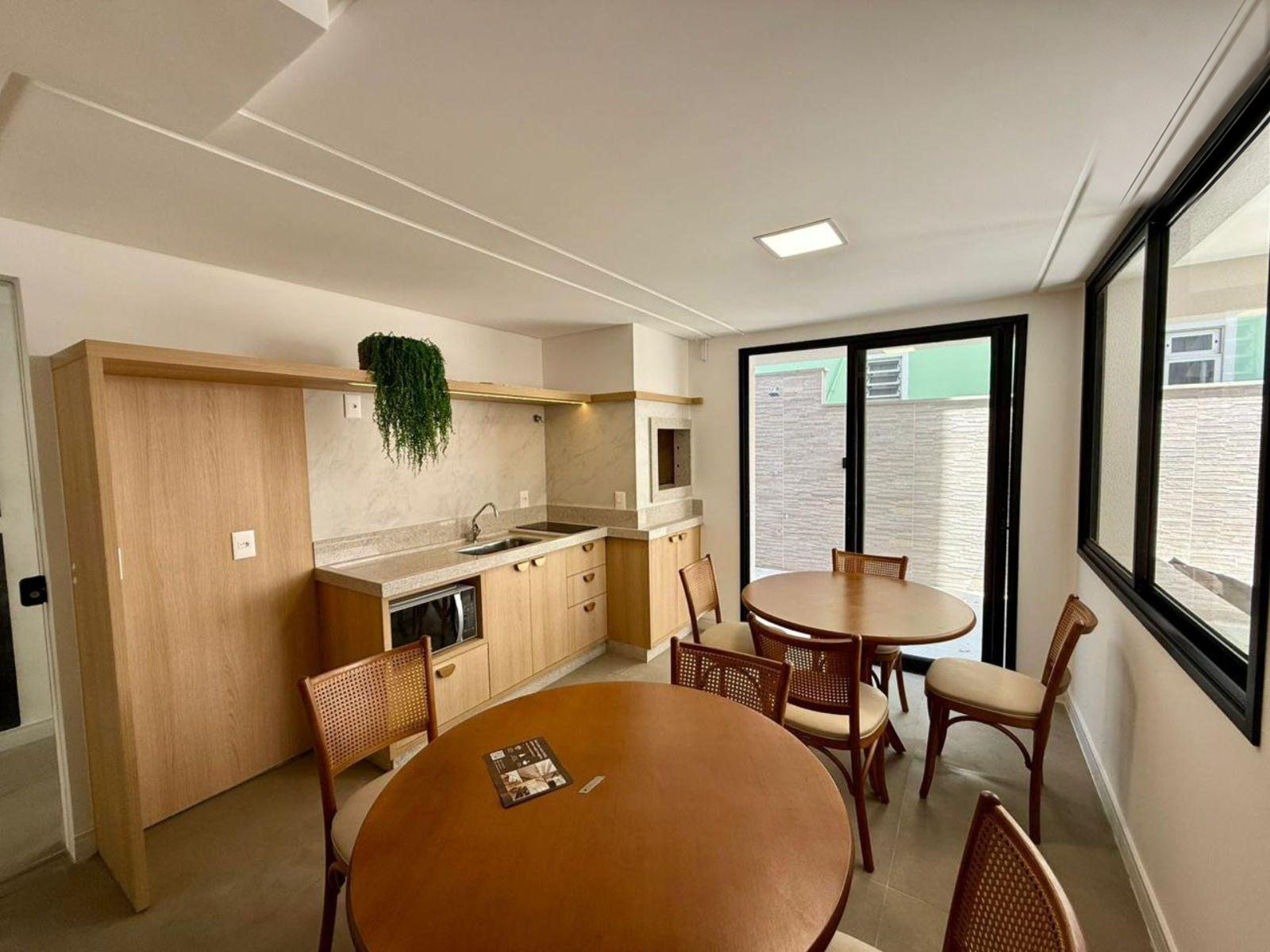 Party room with kitchen, tables and access to the outdoor area