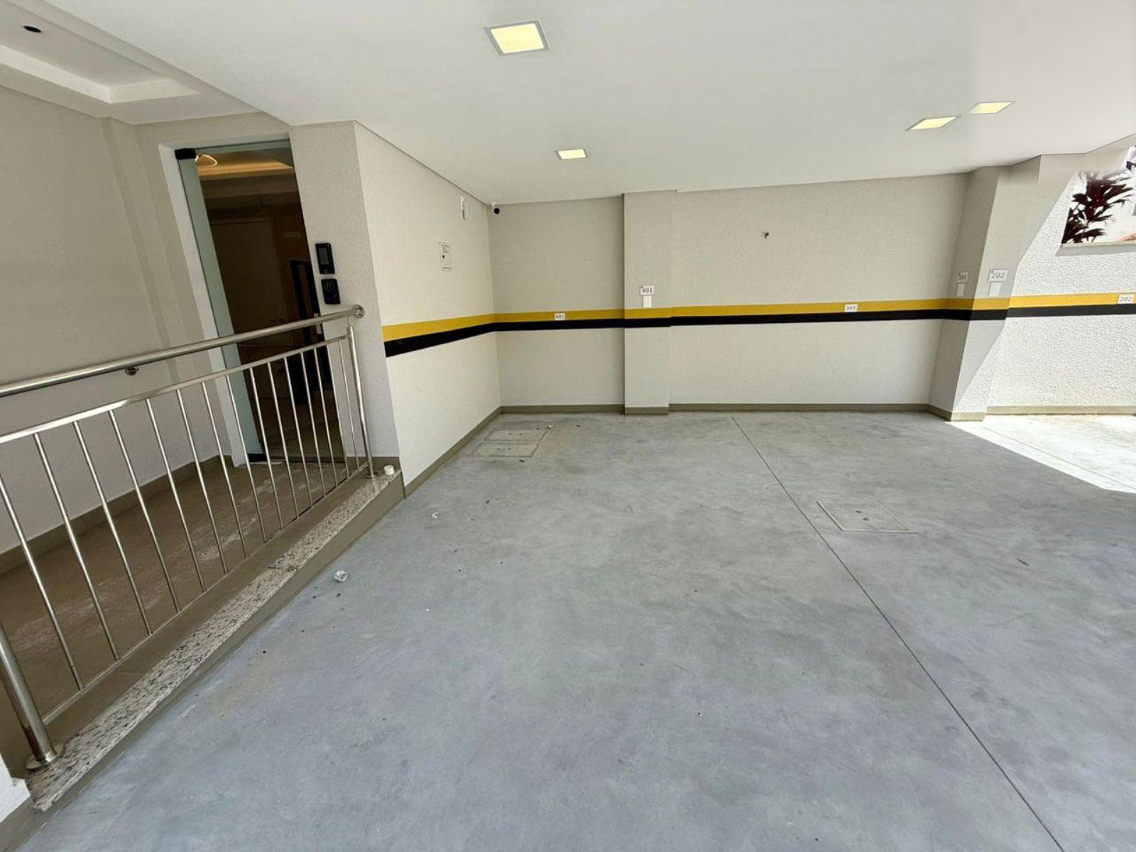 Covered garage with elevator access and marked parking spaces