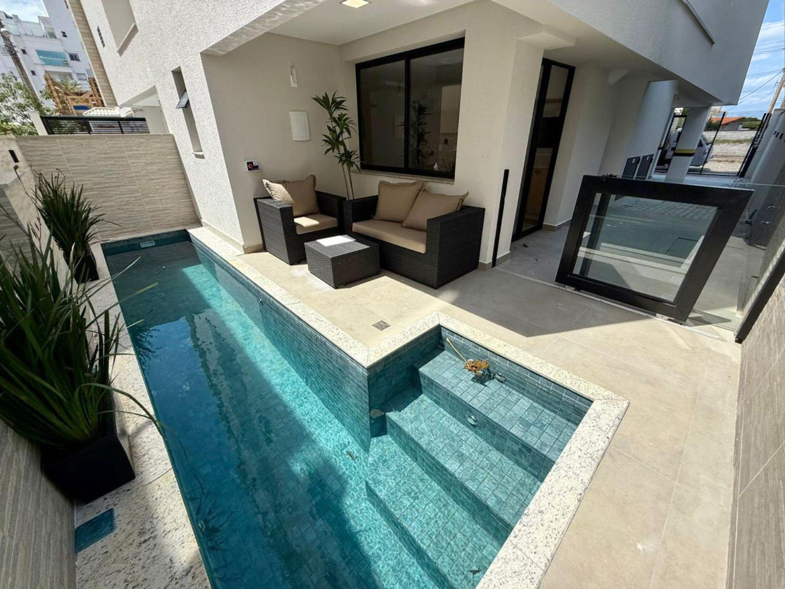 Swimming pool with beach-entry area, outdoor lounge and covered access